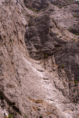 A rocky mountain with a small crevice in it