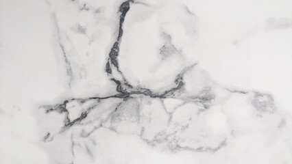 A close-up photo of a white marble surface with grey veining. Ideal for backgrounds, textures, or design elements