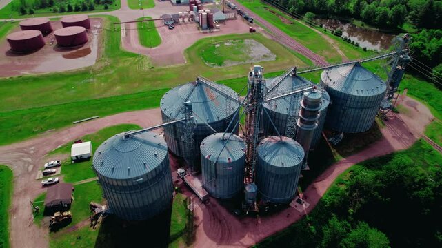 Beautiful aerial aggribusiness concept. Semi truck driver with hopper trailer loads with corn. Wisconsin Rapids, WI, USA
