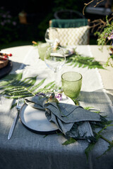 festive table setting, green palette, forest, vegetarian style, natural elements, rustic charm, elegant decor, lush surroundings, wooden table, leafy table runner, fresh foliage, moss accents, white a