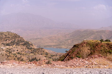 A mountain range with a body of water in the foreground