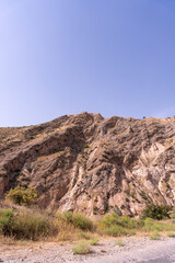 A mountain with a blue sky in the background