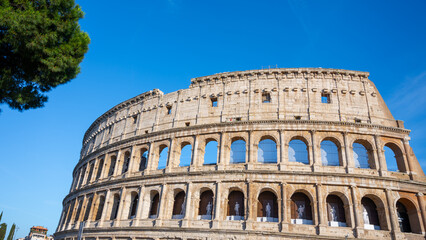 Close-up of the iconic Roman Colosseum with arches and weathered stone facade, capturing the grandeur of this historic amphitheater. Rome, Italy