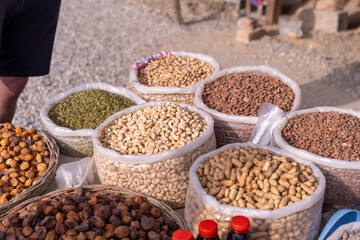 A variety of nuts are displayed in plastic bags