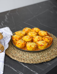 healthy food,cream soup from vegetables and cheese cupcakes on plate in kitchen. no gluten,no sugar recipes.pan and polish in background, flowers as decor.