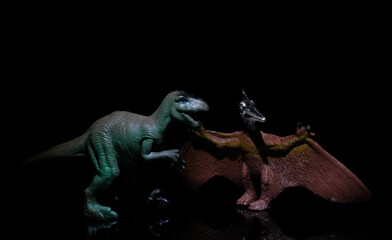 two dinosaurs, a velociraptor and a pterodactyl fight in a prehistoric scenario in a realistic way
