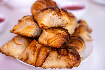 A stack of pastries on a white plate