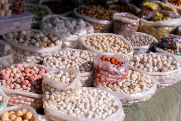 A table full of bags of different colored and sized items