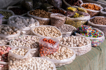 A table full of bags of different colored and flavored candies