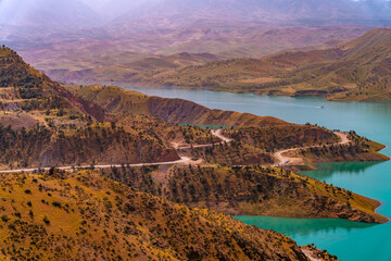 A beautiful landscape with a winding road that leads to a body of water