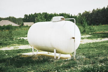 Large white propane tank supplies energy to home