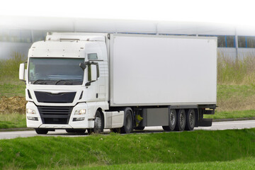 White delivery truck driving through rural area