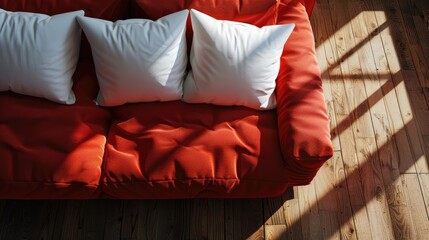Red sofa on wood surface with white pillows