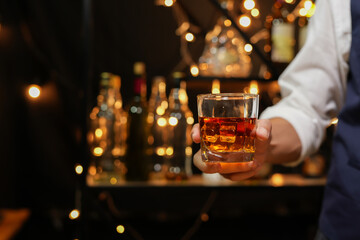 Bartender pouring Whiskey, on  bar