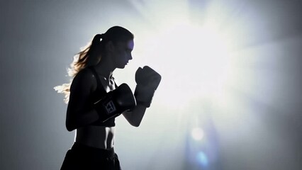 Female boxer silhouette Boxing, energy and woman training for fitness, workout and cardio with a dark silhouette. Exercise, sports and athlete with power, strong and motivation as a boxer at the gym 