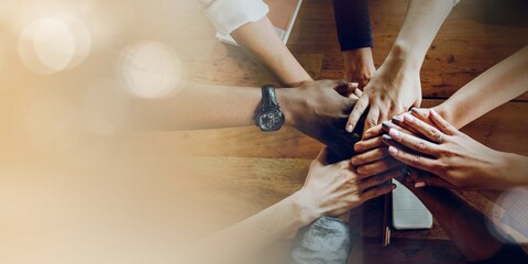 Hands joined over wooden table