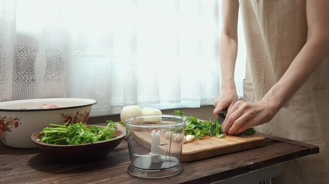 Close-up view of chopping parsley, garlic and onion in blender