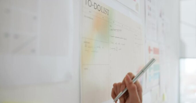Business person, hand and writing with board for checklist, calendar or schedule tasks at office. Closeup of female person, employee or planner with daily to do list for done, finish or completion