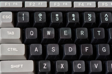 Detail of the keyboard of an old MSX computer with some black function keys, esc, tab, ctrl, shift