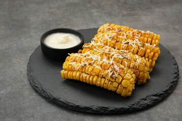 Spicy corn ribs with barbecue sauce and grated cheese
