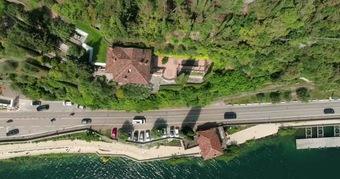 Aerial view of Lake Garda Pieve Italy. beautiful nature Beautiful road along which cars drive on the shore of a lake in the Alps, travel and tourism by car. High quality 4k footage