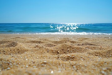 A beach with a clear blue sky and a calm ocean - Powered by Adobe