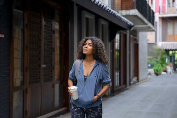 Young Black student woman is living in city.