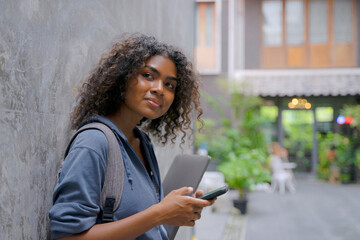 Young Black student woman is living in city.