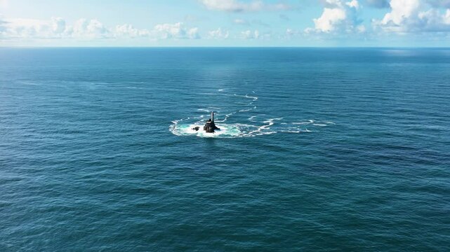 A lighthouse rising out of the ocean. Fastnet lighthouse