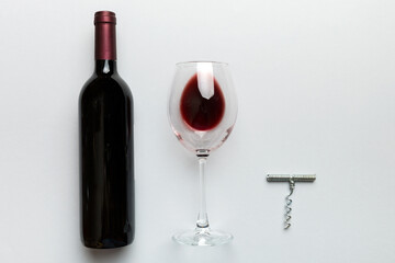 Flat lay composition with corkscrew, bottle of wine and elegant glass on colored table. Flat lay, top view wth copy space