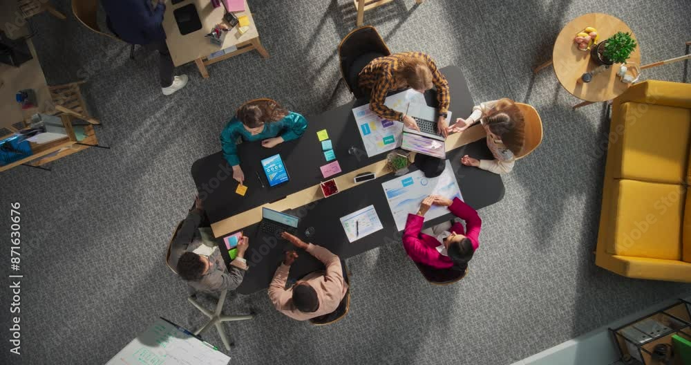 Leinwandbilder top down view: innovative teamwork at office table. diverse professionals collaborate using laptops 