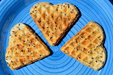 Homemade baked savory heart-shaped waffles on a blue plate