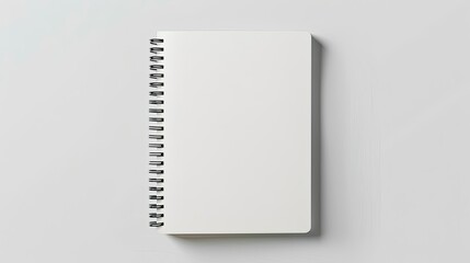 Closed spiral-bound notepad, blank mockup on a clean white background