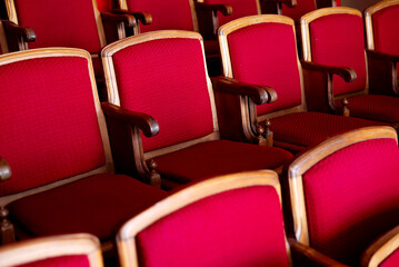 Fototapeta premium red empty seats for spectators in the theater or cinema close-up