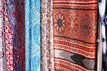 silk Indian scarves with a bright colorful pattern at an Asian bazaar in India closeup