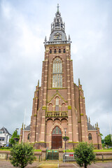 Fototapeta premium View at the Great church in the streets of Schagen in Netherlands