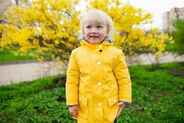 Girl in Yellow Raincoat by Tree