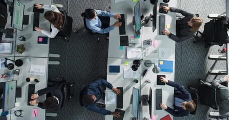 Top Down View of Diverse Team Working on Desktop Computers in an Office. Collaborative Environment With Constant Activity, Discussions, and Document Sharing, Creating an Efficient Workspace.