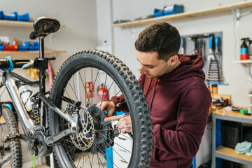 The mechanic inspects the rear cassette of a mountain bike wheel