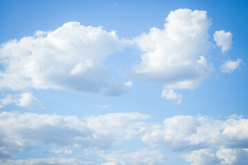 Blue sky with white clouds, shot on a sunny summer day.