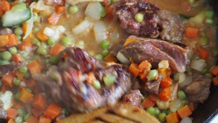 Stir-fry meat and vegetables in an iron skillet. wok stir fry with selective focus