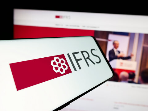 Stuttgart, Germany - 06-26-2024: Smartphone with logo of International Financial Reporting Standards Foundation (IFRS) in front of website. Focus on center of phone display.