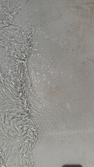 Trendy summer nature banner. Defocused liquid clear water surface texture with splashes bubbles with copy space. Water waves in sunlight background.	
