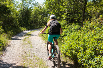 Fototapeta premium Cyclist on forest path
