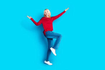 Fototapeta premium Full size photo of pretty senior female dancing have fun wear trendy red outfit isolated on blue color background