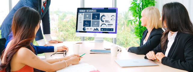 Human resources management software on computer screen helping human resources employee to manage...