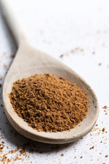 Coconut palm sugar on a wooden spoon isolated on white background