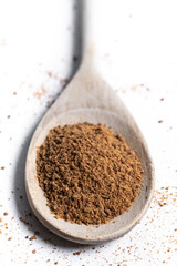 Coconut palm sugar on a wooden spoon isolated on white background