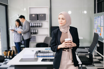 Young attractive female office worker business suits smiling at camera in office .
