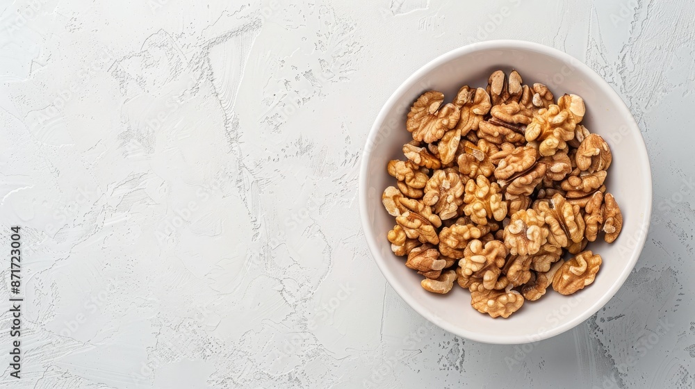 Poster walnuts in white bowl from top flat lay with space for text